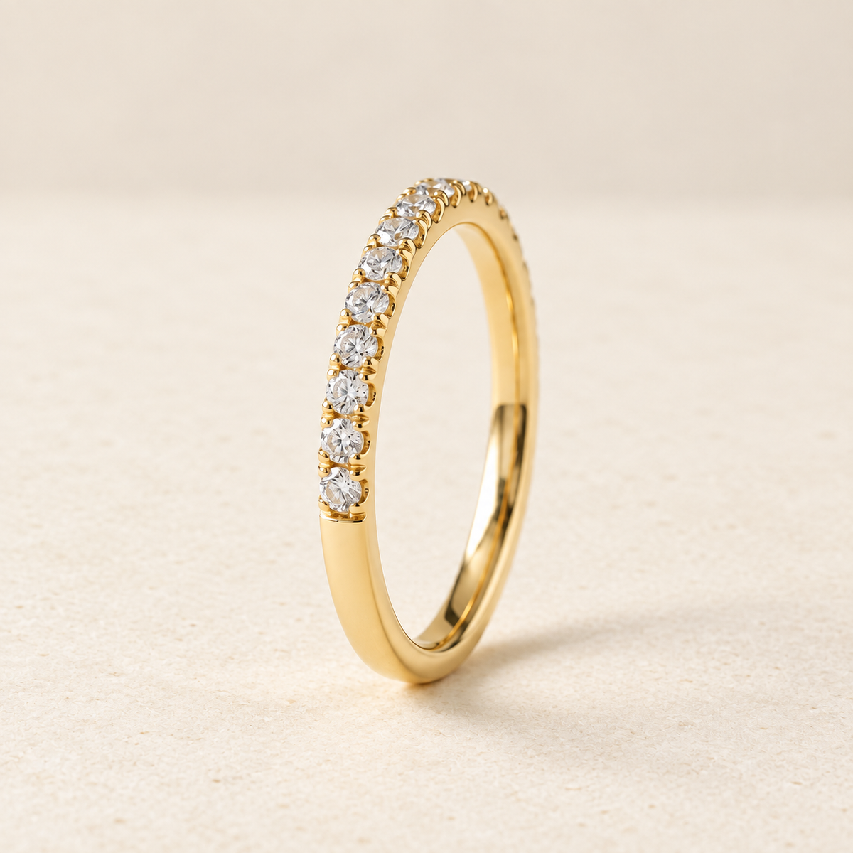 AI-generated visualization — Lab Diamond Half-Eternity Pavé Band in yellow gold, warm ivory studio display