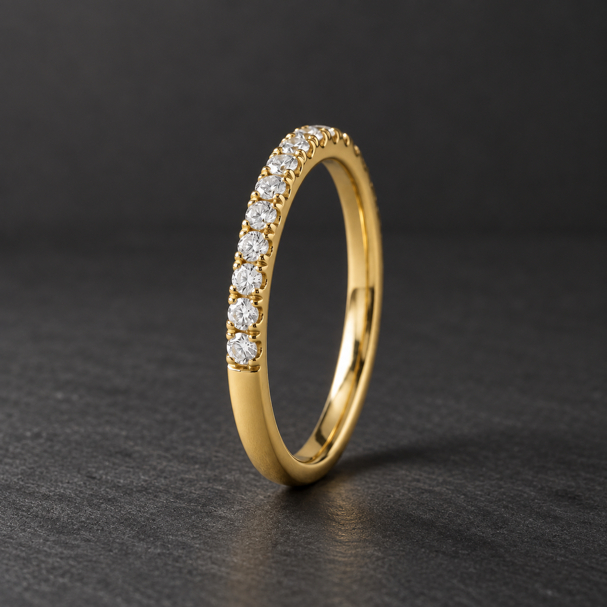 AI-generated visualization — Lab Diamond Half-Eternity Pavé Band in yellow gold, dark graphite editorial setting