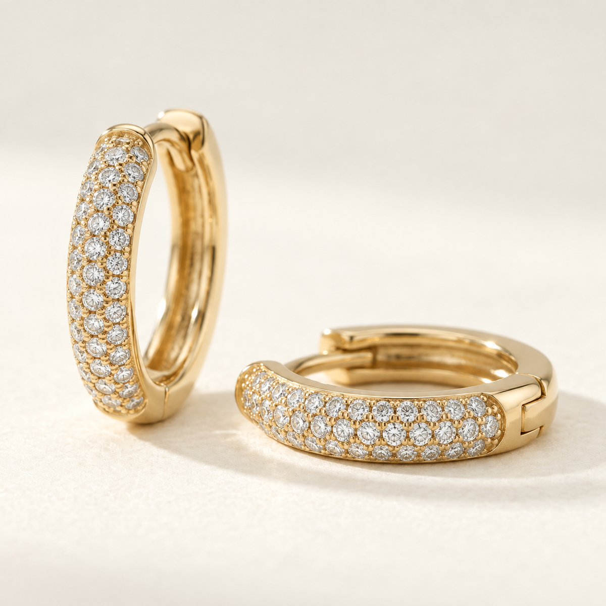 AI-generated visualization — close detail of the three-row pavé setting on yellow-gold Pavé Huggie Hoops.
