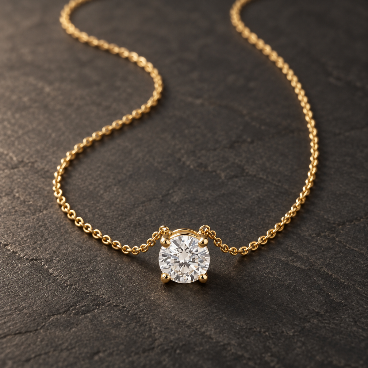 AI-generated visualization — yellow-gold four-prong Solitaire Pendant Necklace on dark graphite.