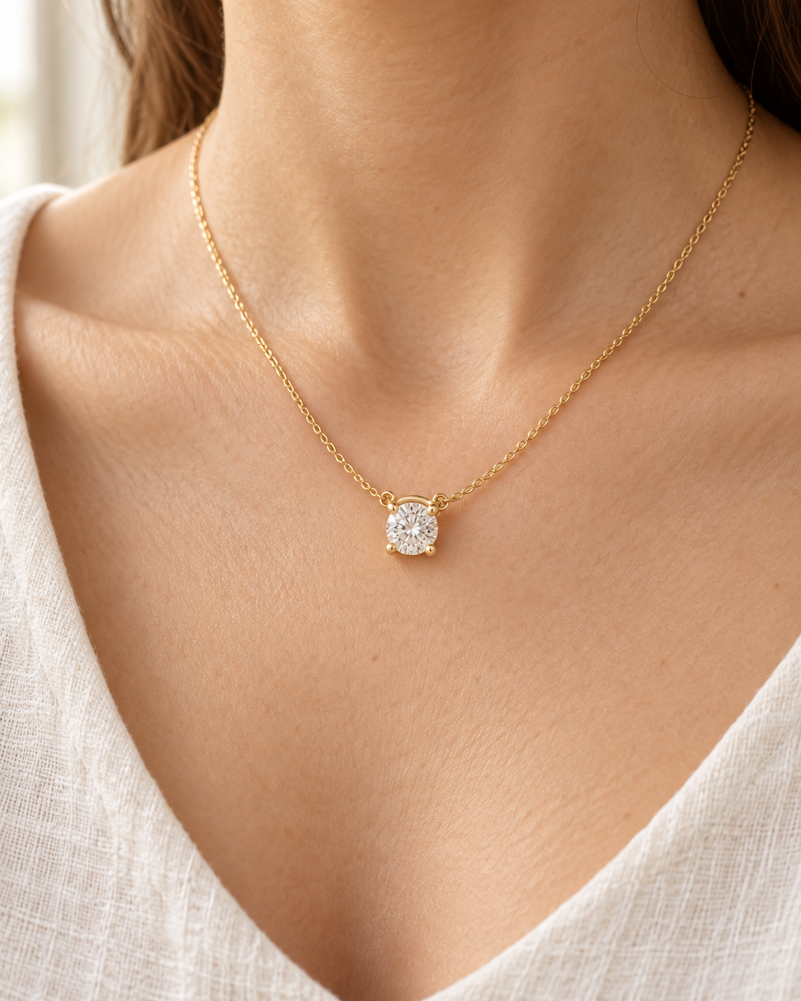 AI-generated visualization — yellow-gold four-prong Solitaire Pendant Necklace worn at the collarbone.