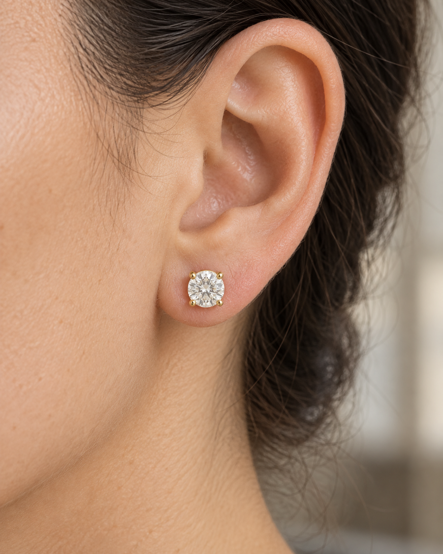 AI-generated visualization — a yellow-gold four-prong Lab Diamond Stud Earring worn on an adult ear.