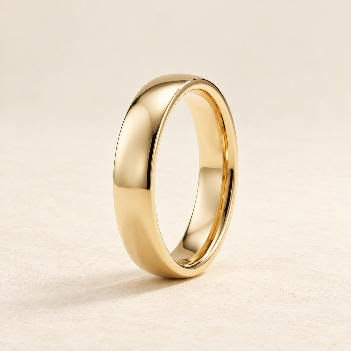 AI-generated visualization — Signature Comfort-Fit Band — 4 mm in yellow gold, warm ivory studio display