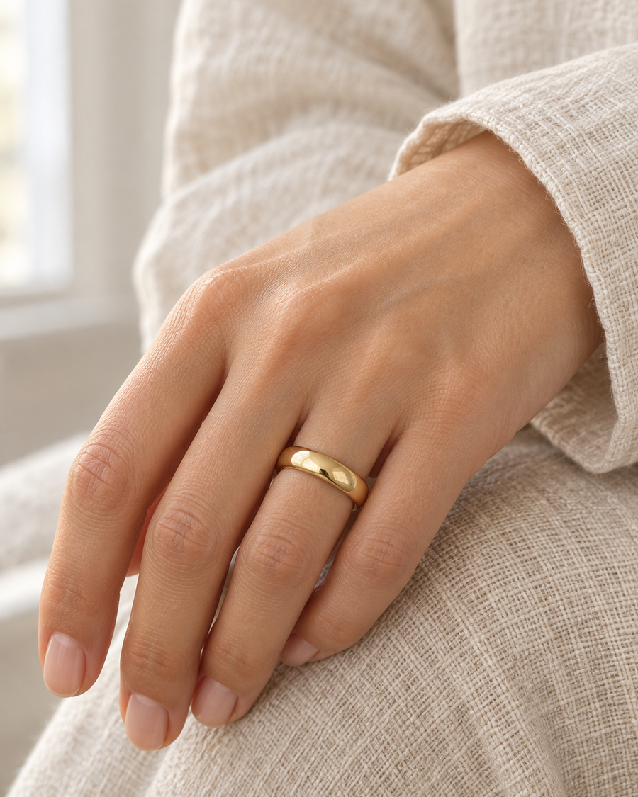 AI-generated visualization — Signature Comfort-Fit Band — 4 mm in yellow gold, comfort-fit band on an adult hand